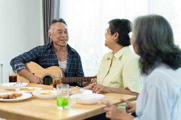Three Senior friends bonding over music, singing and laughter in party