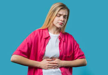 Young woman squeezing belly with hands. abdominal pain, suffering stomach ache