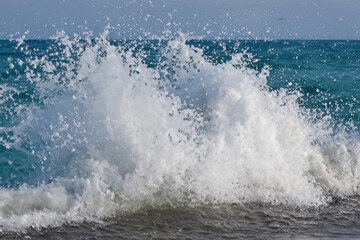 Fototapeta premium Waves splashing in the water. Wave ocean splash concept. White waves with splashes of water in the sea. A man splashes white water with waves in the sea lifestyle.