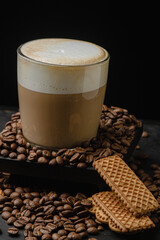Cup of cappuccino on a dark background. Coffee drink