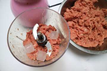 raw ground beef and ice cubes. mixture preparing to make fresh meatball, gourmet hamburgers, or another food meal. With ice cubes.