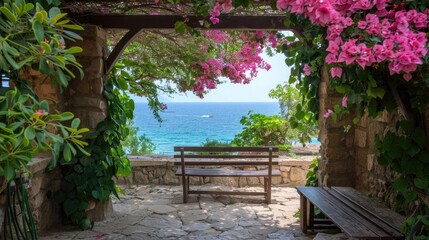 Obraz premium A wooden bench sits in the shade of a stone archway, overlooking the sparkling blue Mediterranean Sea. Pink flowers bloom profusely from a vine growing on the archway