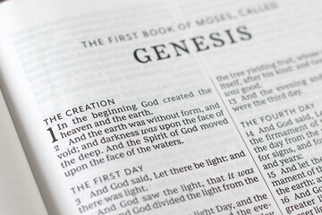 Open holy bible book of Genesis, the creation of God Jesus Christ verses. Close-up. Studying old...