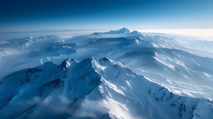 Fototapeta premium Aerial View of a Serene Mountain Range, Capture the tranquil beauty of a snow-capped mountain range from a bird's-eye perspective.