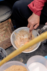 a typical food from betawi the province of DKI Jakarta, Indonesia made from eggs and sticky rice usually called kerak telor, being cooked in the traditional way