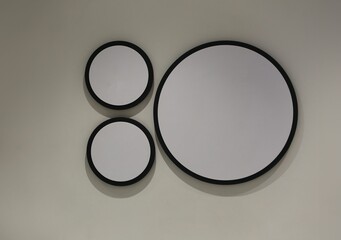 Blank circular wooden sign on a gray wall.