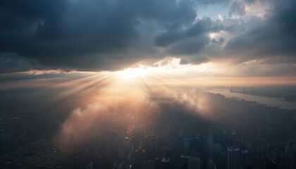 Dramatic aerial view of cityscape with sunbeams breaking through clouds at sunrise, casting ethereal light over buildings and rivers.