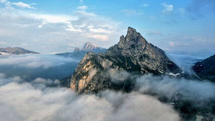 Mountain massif partially shrouded in clouds in the Italian Dolomites