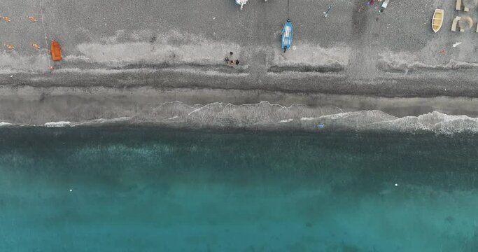 Aerial view of boats and shoreline with clear turquoise water in Lipari, Aeolian Islands, Italy.