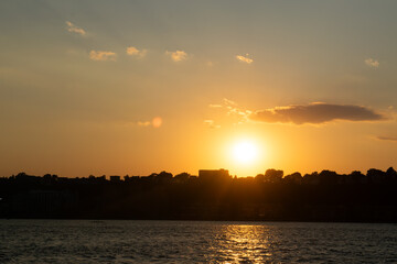 Naklejka premium sunset over the river