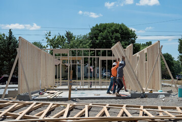 Construction Workers Raise Studded Wall Unit