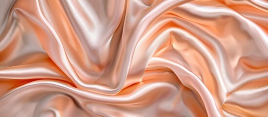 Fototapeta premium Luxe peach satin silk fabric with elegant wavy texture, perfect as an abstract background. Features copy space image.