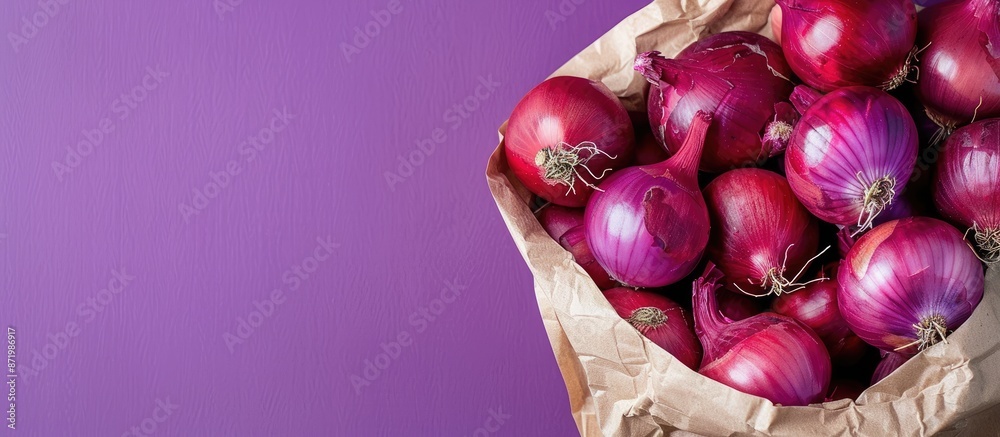 Poster close up of red onions in a paper bag on a purple background with copy space image.