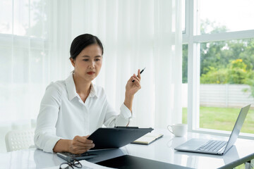 Businesswoman is thinking and is stressed about work.