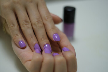 Close-up of hand nails. Close-up of hand nails with purple nail polish. Personal care Beauty and elegance.