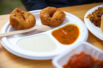 the indian street food in a disposable paper trays