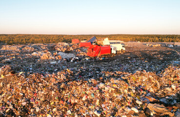 Landfill garbage truck. Garbage truck unloads rubbish in landfill. Landfill waste disposal. Garbage...