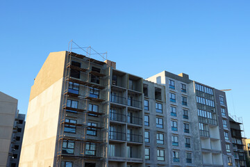 Plastering the facade building. Residential buildings Construction. Plaster facade. Application Of Facade Plaster. Plaster facade, wall decoration. Applying plastering mortar to outer wall.