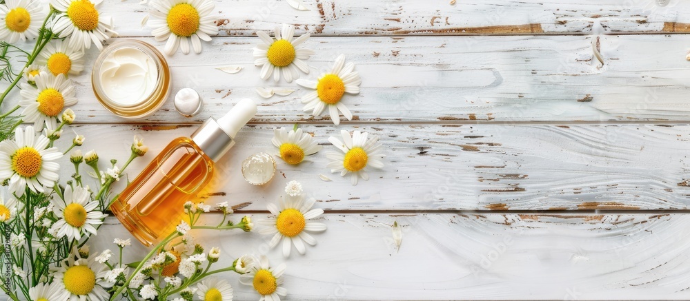 Poster chamomile flower beauty product samples displayed on a white wooden table with copy space image.