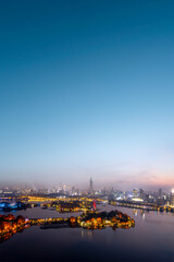 Vibrant City Skyline at Sunset with Illuminated Buildings