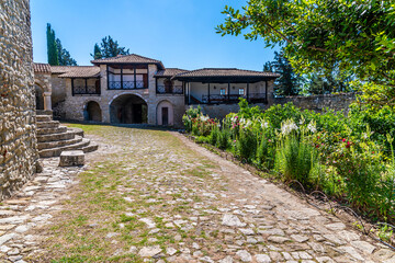 A view across the courtyard towards the outer wall of the Ardenica Monastery in Albania in the morning in summertime