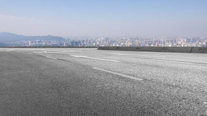 Empty Road Overlooking Cityscape in Hazy Weather