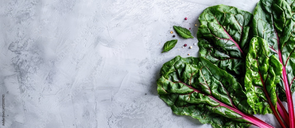 Aufkleber Top view of healthy and highly nutritious raw chard leaves on a light background with copy space image.