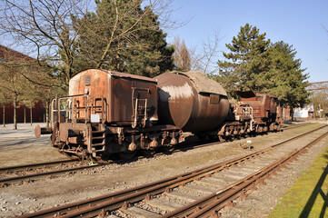 Obraz premium Forgotten relic of industrial transportation: an old metallurgical freight car, weathered and rusted, once used for molten metal. Its corroded metal surface tells a story of industrial history, captu