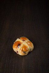 Buns with raisins on a black dark background