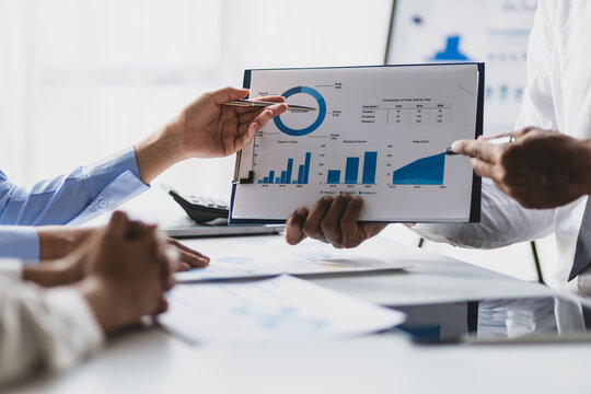 Business consulting meeting is discussing business plan analysis with financial data and business growth charts to plan strategies for generating company profits.