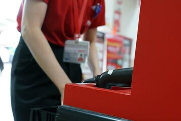 A blur employee was preparing service a customer payment of a gate slot area in the supermarkets.