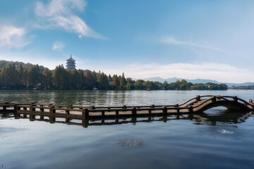 Naklejka premium Serene Lake with Traditional Pavilion and Wooden Bridge