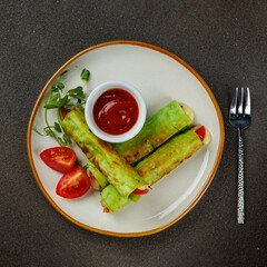Healthy vegetarian breakfast. Small lavash rolls with spinach, mozzarella and tomatoes with tomato sauce. Dark background. Simple recipe. Menu of cafes, restaurants. Snack for children.