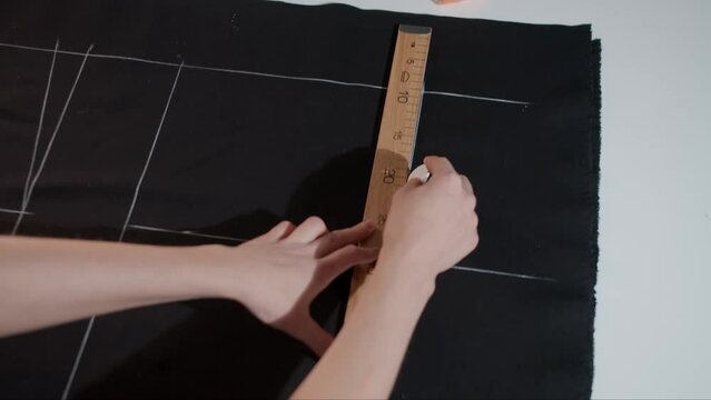 Woman Marking Fabric in Studio