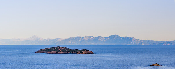 Greek island panorama view, seascape with the blue Aegean waters. Deserted tropical Island, dream holiday, vacation destination. 