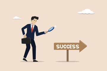 Looking for the path of success, finding business direction, success challenge concept, businessman looking for the direction of business success with a magnifying glass.