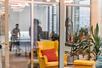  Business colleagues take a break from work to enjoy a game of table tennis, fostering teamwork and camaraderie in the workplace