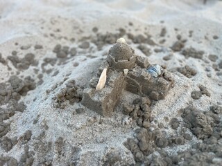 castle in the sand on a beach.