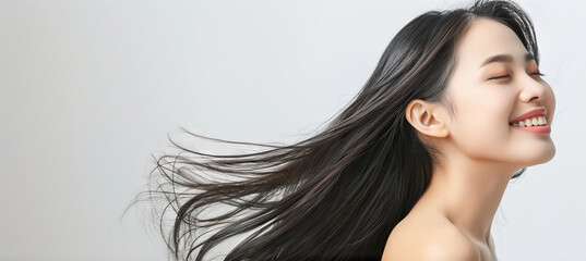 Fototapeta premium Beautiful young Asian woman practicing skincare or hair salon. smooth face touches her healthy facial. Smiling Asian girl model has natural makeup touches glowing, hydrated skin. Copy space for text