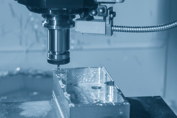 The CNC milling machine tapping process at  aluminum parts in the light blue scene.