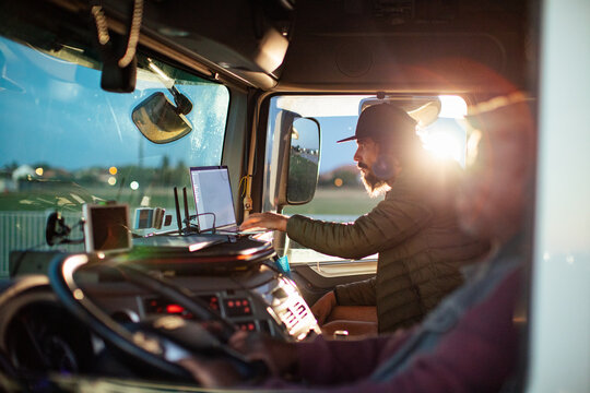 Mature male truck driver at the wheel on the road