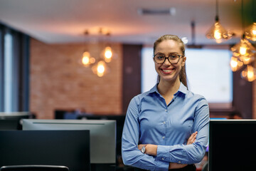 Confident Businesswoman: Blonde Executive Demonstrating Leadership with Crossed Arms.
