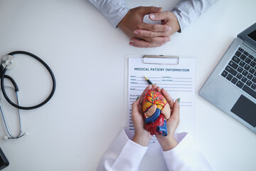 realistic looking heart model in hands of doctor is symbol of campaign to care for the health of...