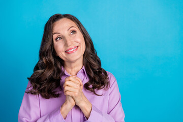 Photo of adorable lovely woman wear violet shirt arms chest looking empty space isolated blue color background