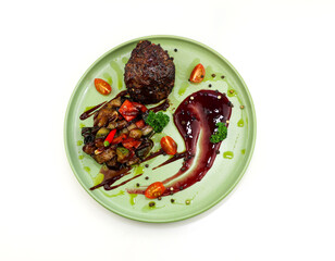 Appetizing steak with baked vegetables and sauce