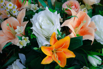 A bouquet of flowers with a mix of white and orange flowers