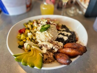  Plate of Mexican food with plantains and corn