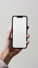 A close-up of a hand holding a smartphone with a blank screen, perfect for app or website mockups and presentations..