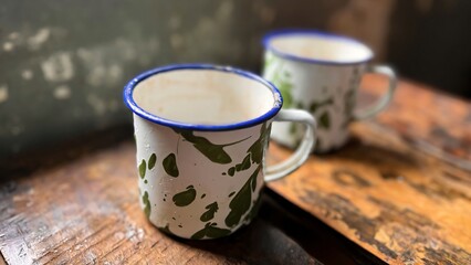 The old tin cup utensils on the table in the Asian prison ward, local called as cangkir blirik, drinking tin cup used in Asian prisons some old days