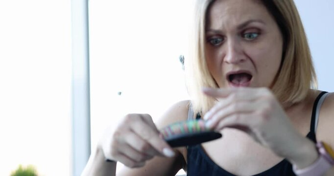 Young woman combs hair and screams from falling out. Female pattern baldness